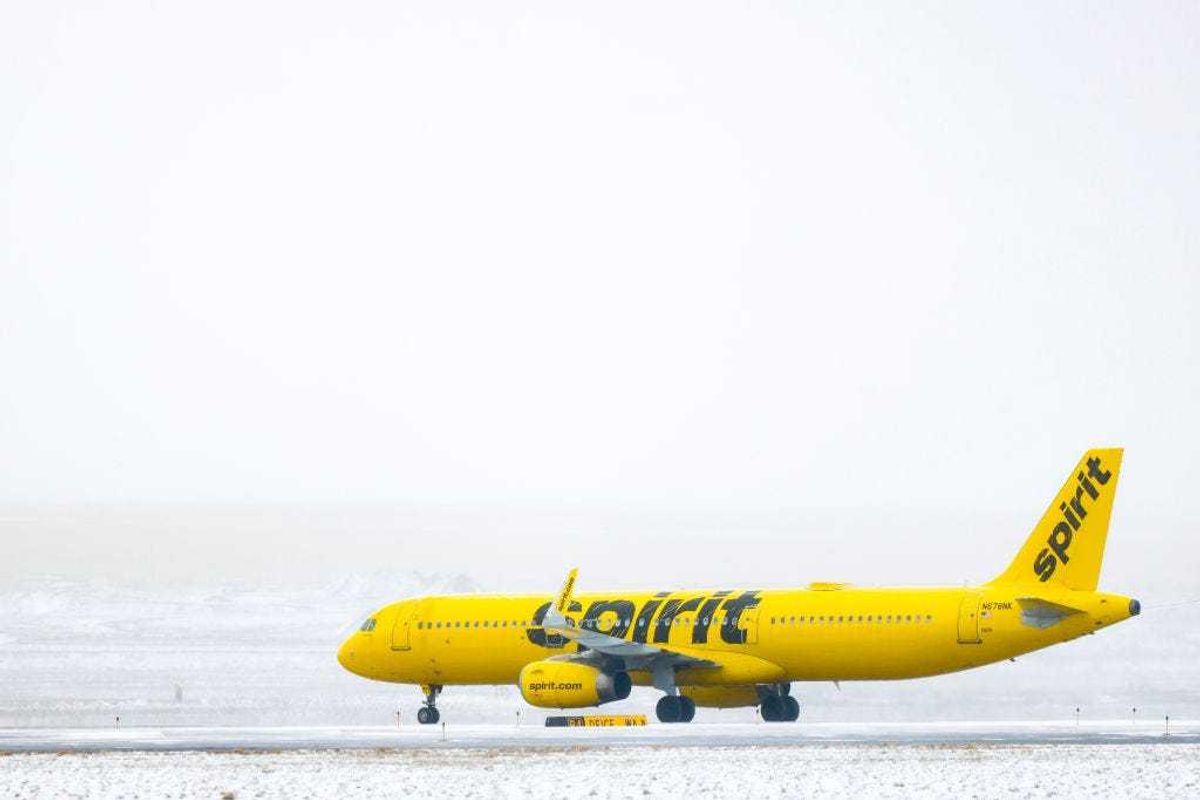 A Spirit Airlines airplane taxis toward a runway during a winter storm at Denver International Airport on February 22, 2023 in Denver, Colorado.