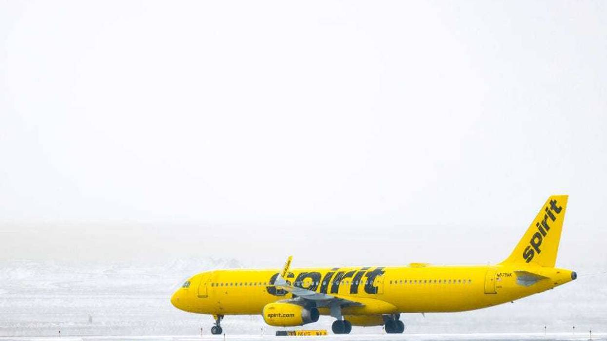 A Spirit Airlines airplane taxis toward a runway during a winter storm at Denver International Airport on February 22, 2023 in Denver, Colorado.