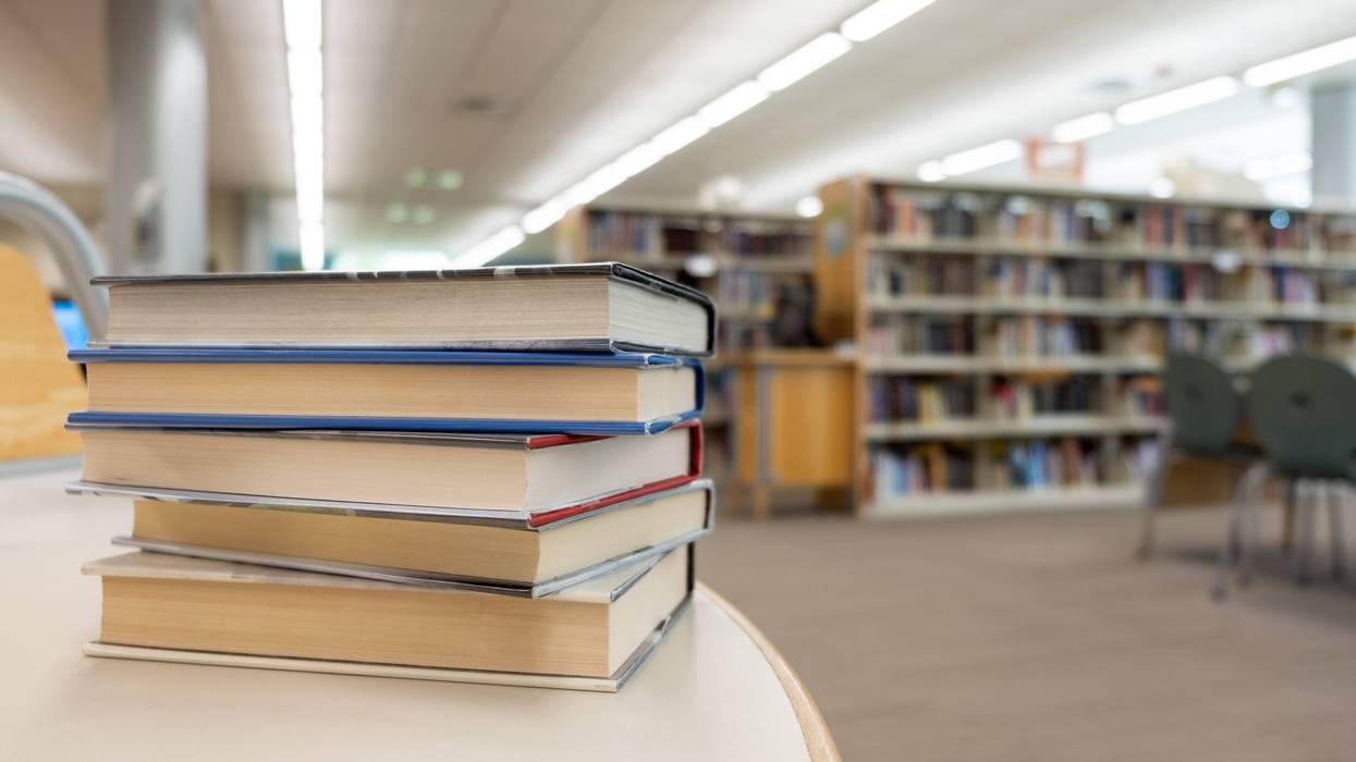 A stack of books on a library table