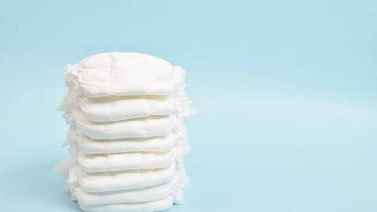 A stack of disposable panties on a blue background