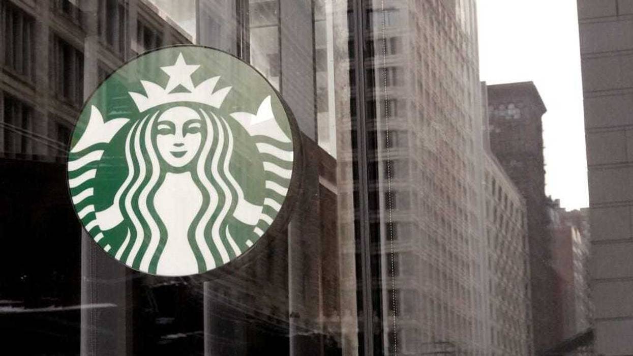 A Starbucks sign hangs above the entrance of one of the chain's coffee shops in the Loop on January 04, 2022 in Chicago, Illinois.
