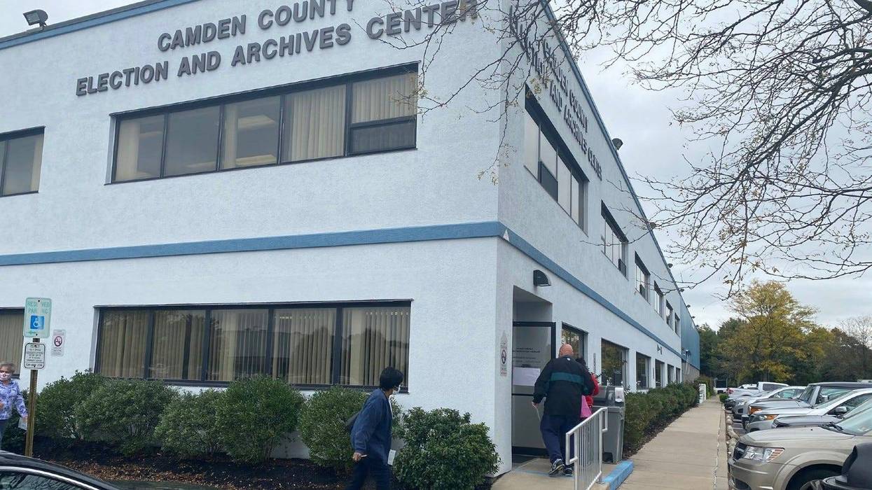 A steady stream of voters hand deliver ballots to the Election Office in Camden County.