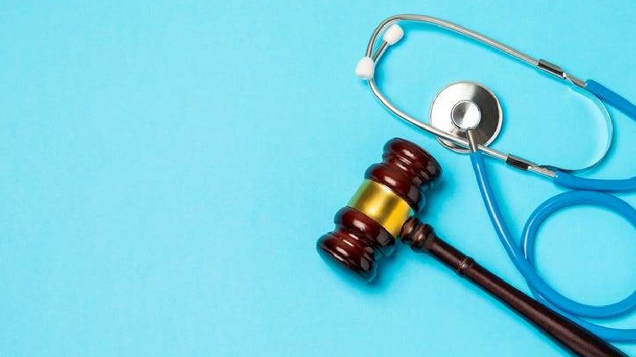 A stethoscope and reflex hammer on a desk