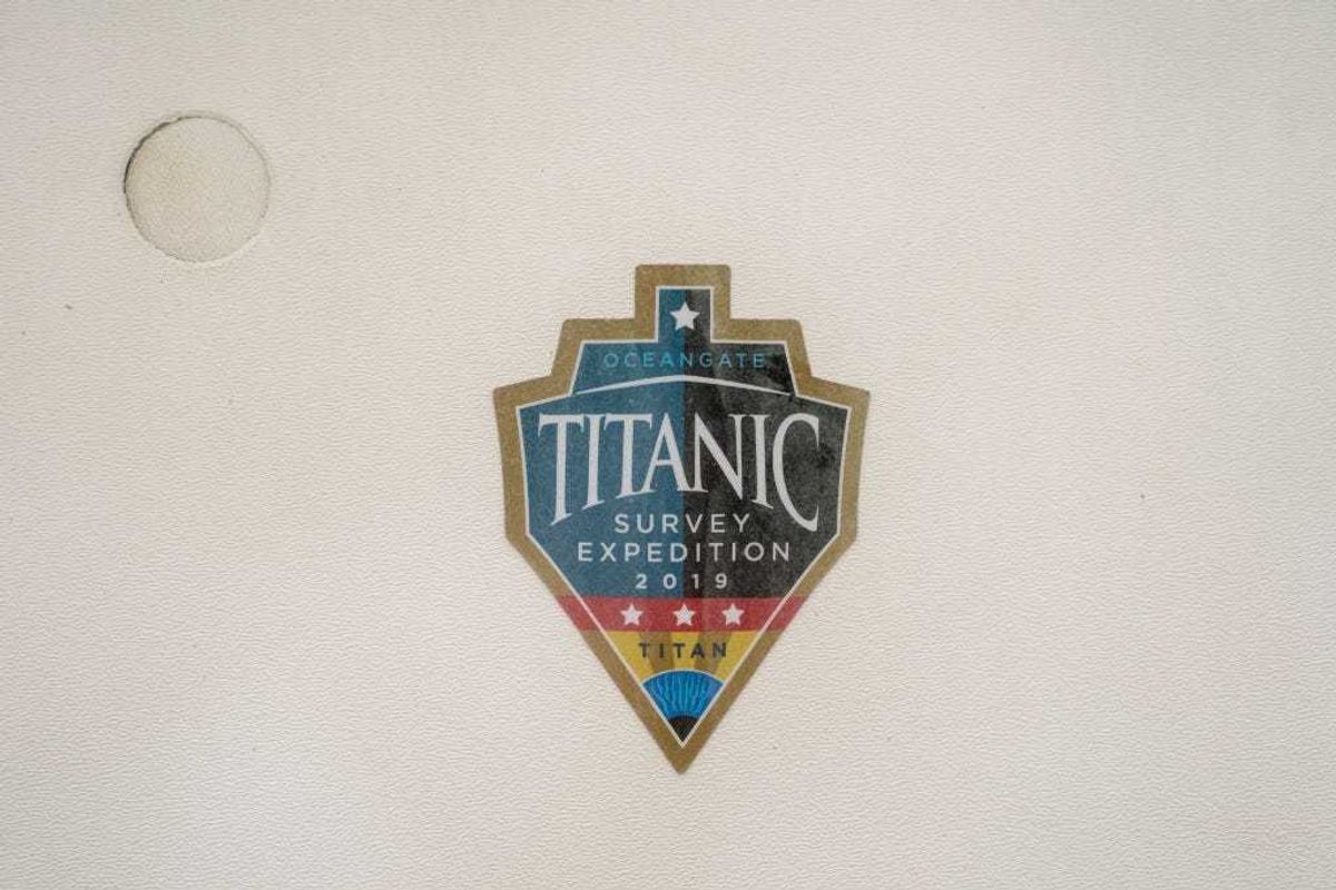 A sticker from a 2019 Titanic survey expedition is seen in a window of the OceanGate offices on June 21, 2023 in Everett, Washington.