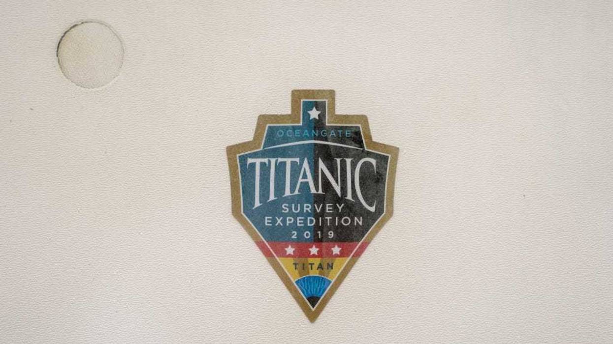 A sticker from a 2019 Titanic survey expedition is seen in a window of the OceanGate offices on June 21, 2023 in Everett, Washington.