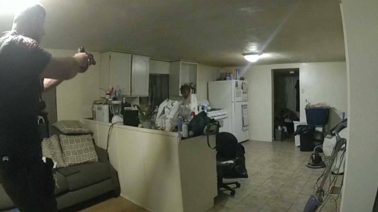 A still taken from body-worn camera footage shows Sangamon County Sheriff's Deputy Sean Grayson point his gun at Sonya Massey, seconds before he shot and killed her. Massey had called 911 earlier to report a prowler outside of her home.