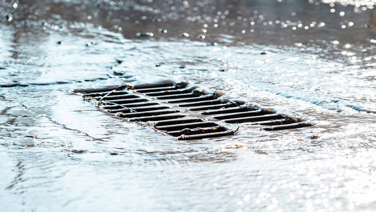 A storm water grate - stock photo