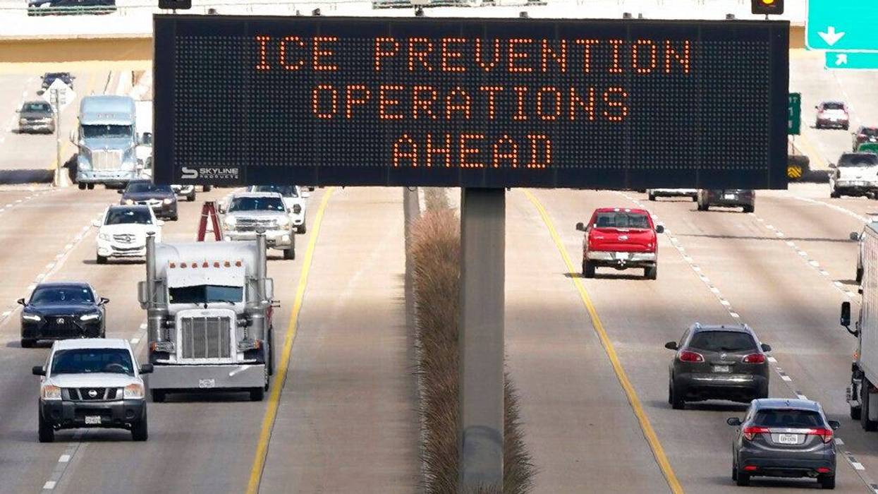 A street sign warns drivers of ice prevention operations on highways ahead of winter weather in Dallas