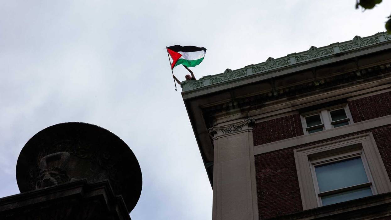 A student Pro-Palestinian protestor occupying Hamilton Hall waves a Palestinian flag on the roof of the building at Columbia University on April 30, 2024 in New York City. Columbia University has restricted access to the school's campus to students residing in residential buildings on campus and employees who provide essential services to campus buildings after protestors took over Hamilton Hall overnight renaming it as "Hind's Hall" in honor of Hind Rajab. The students have barricaded themselves in the building and have also erected another encampment on Lewisohn Lawn, outside Lewisohn Hall. The protesters have said they are planning to remain at the hall until the university concedes to CU Apartheid Divest’s three demands: divestment, financial transparency and amnesty. (Photo by Michael M. Santiago/Getty Images)