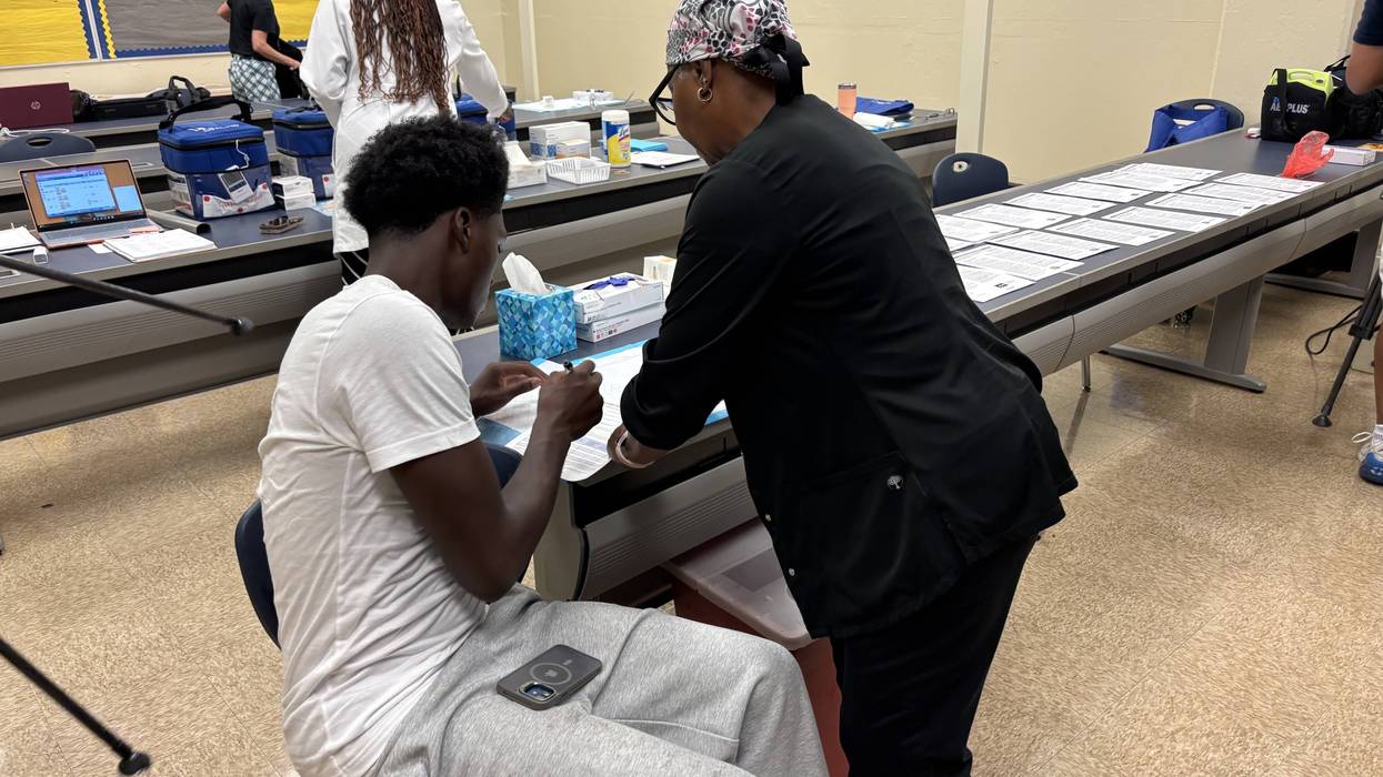 A student receives a vaccination during a clinic at Benjamin Franklin High School on Aug. 27, 2026.