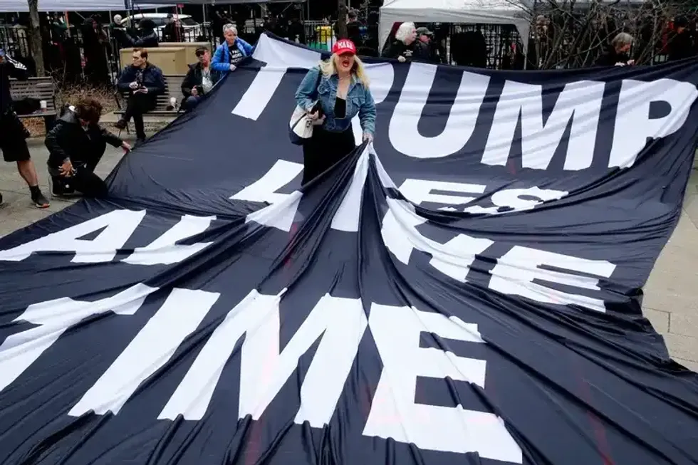 A supporter of Donald Trump argues with opponents outside Manhattan Criminal Court on April 4, 2023.