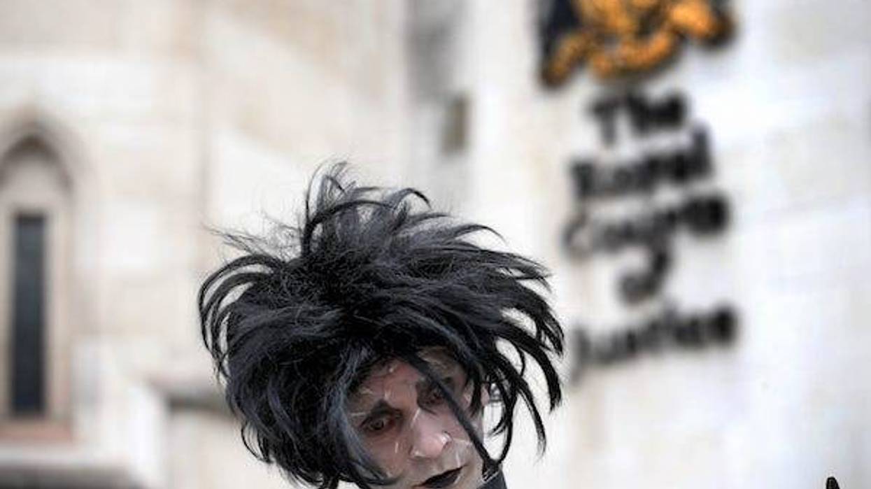 A supporter of Johnny Depp, dressed as Edward Scissorhands played by Depp in the 1990 Tim Burton film of the same name, waits outside the Royal Courts of Justice in London