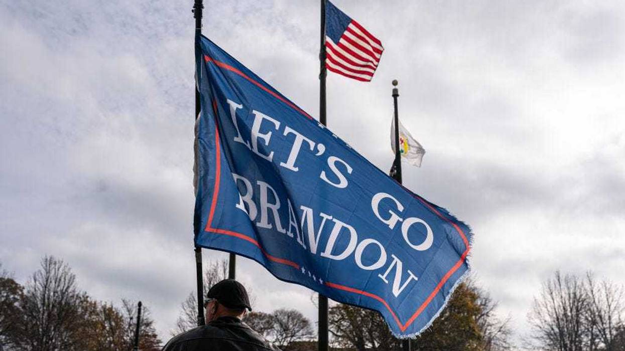 A supporter of Kyle Rittenhouse flies a Lets Go Brandon flag in front of the Kenosha County Courthouse while the jury deliberates the Rittenhouse trial on November 16, 2021 in Kenosha, Wisconsin.