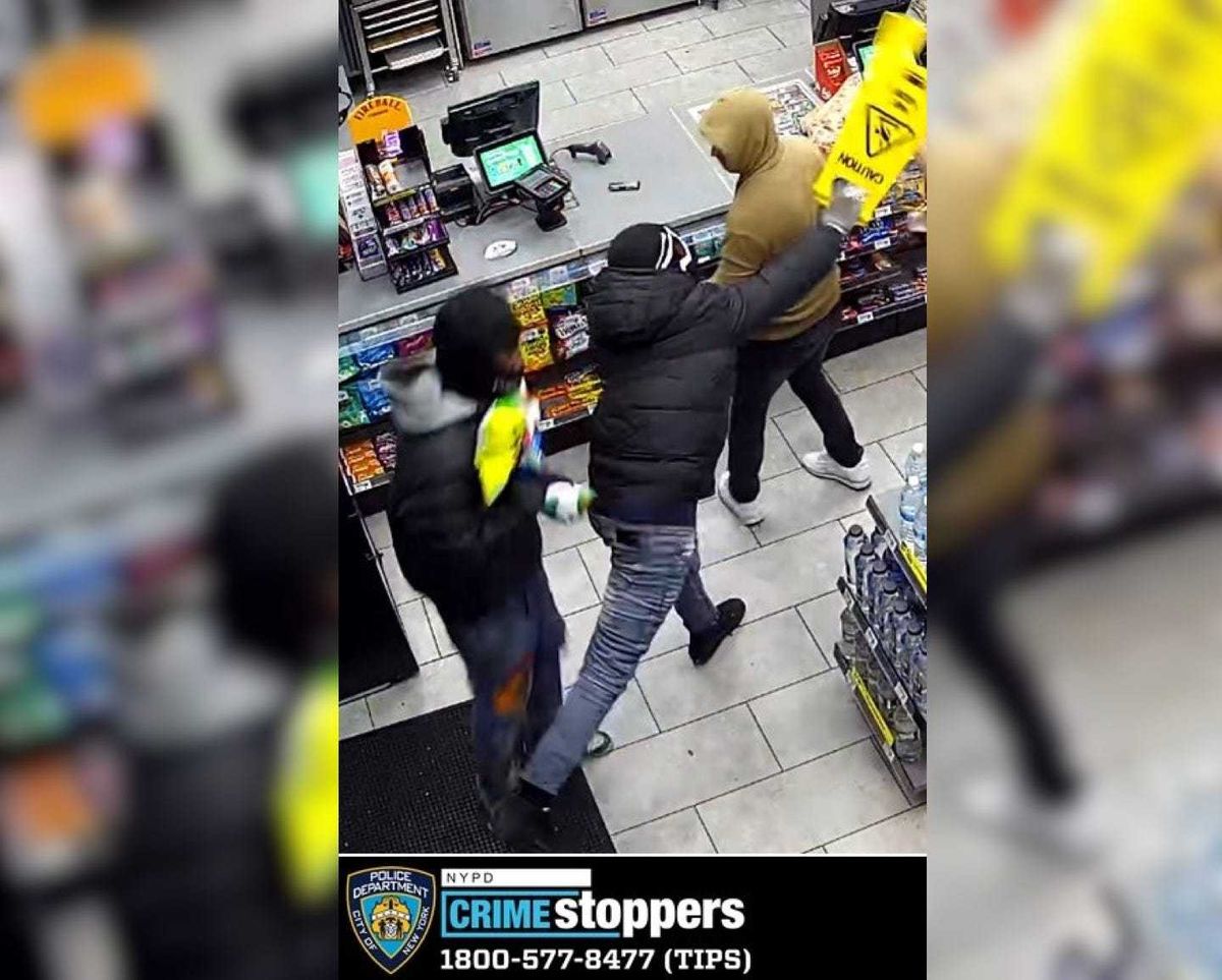 A surveillance image shows the 7-Eleven worker being hit with a "wet floor" sign at a store on Sixth Avenue