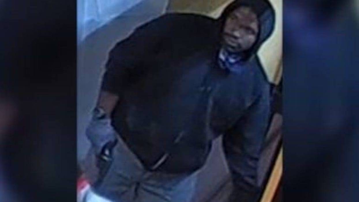 A surveillance photo taken during the homicide of a Dunkin' Donuts worker in Philadelphia. A man charged in this case has also been charged with his mother's death.