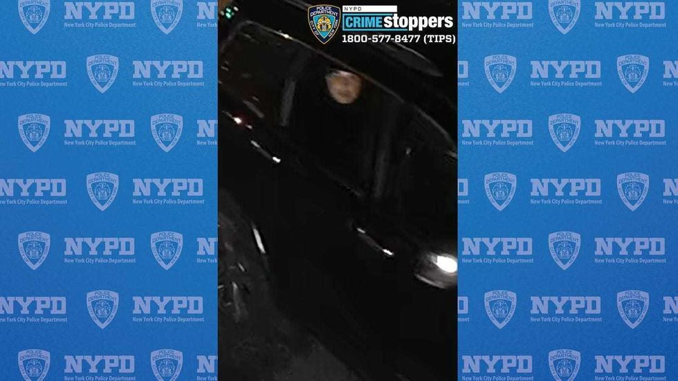 A suspect is seen in the back of a getaway car in a police photo