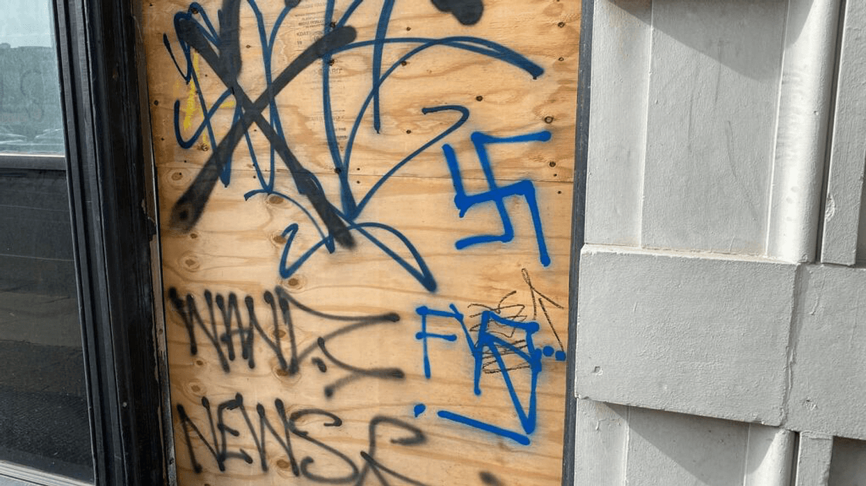A swastika is spray-painted on an empty building at 23rd and Market streets