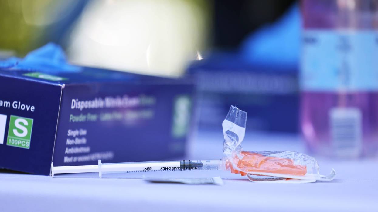 A syringe prepared with the Pfizer-BioNTech coronavirus (COVID-19) vaccine sits on a table at a #VAXTOSCHOOL pop-up site at Life of Hope Center on October 21, 2021 in New York City.