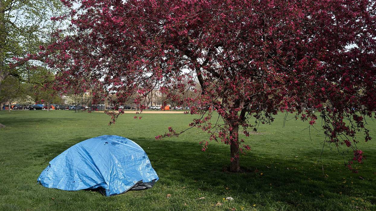 A tarp covers a tent in Humboldt Park