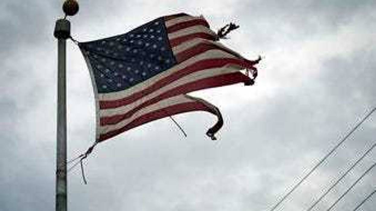 A tattered American flag blows in the wind in the aftermath of Hurricane Laura Thursday, Aug. 27, 2020, in Port Arthur, Texas. (AP Photo/Eric Gay)