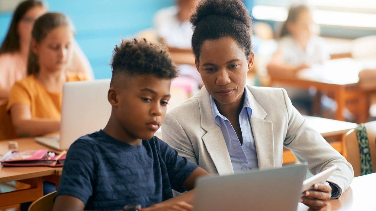 A teacher and student in a classroom.