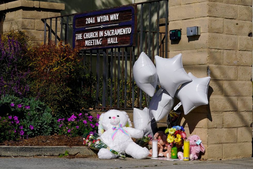 A teddy bear, balloons and flowers are among the items left at growing memorial at The Church in Sacramento, Calif., on Tuesday, March 1, 2022. Authorities say a man shot and killed his three daughters, their chaperone and himself during a supervised visit with the girls at the church on Monday.