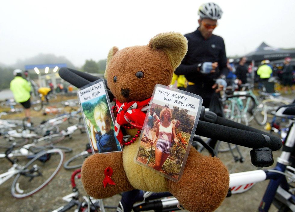 A teddy bear with photos of lost loved ones adorns a bicycle at a rest stop during the first day the second annual AIDS/LifeCycle event June 8, 2003 in San Bruno, California.