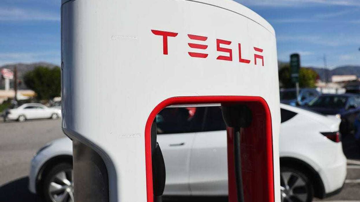 A Tesla electric car pulls up to recharge at a Tesla Supercharger station on January 16, 2024 in Burbank, California.