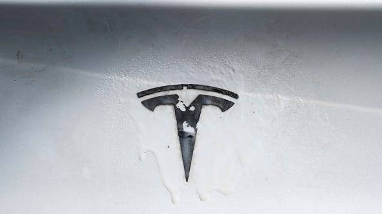 A Tesla emblem is seen being removed from a Tesla vehicle during a "de-badging" event on April 12, 2025 in Seattle, Washington. Held during a protest outside a Tesla retail location in Seattle, the event allowed anyone to bring their Tesla for free removal of its Tesla emblems. (Photo by David Ryder/Getty Images)