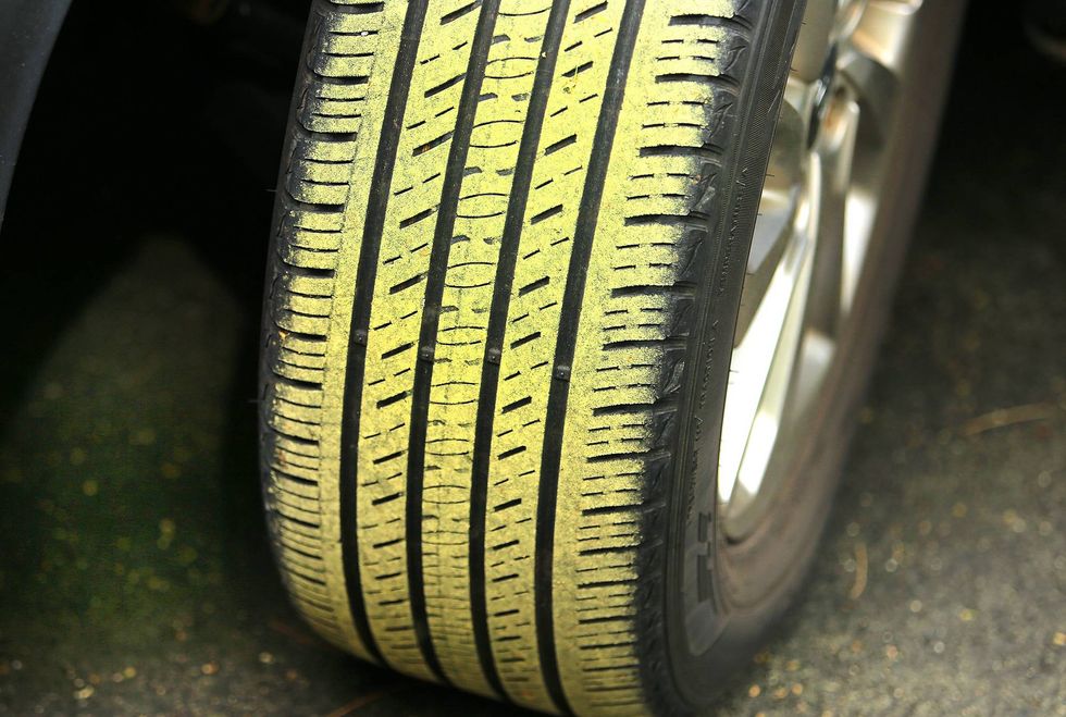 A tire is covered in pollen in Pembroke, Massachusetts, June 7, 2022.