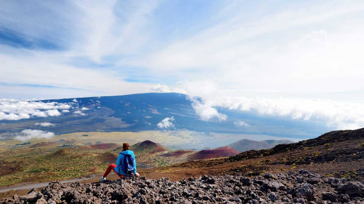 A tourist looking at Mauna Loa volcano on the Big Island of Hawaii.