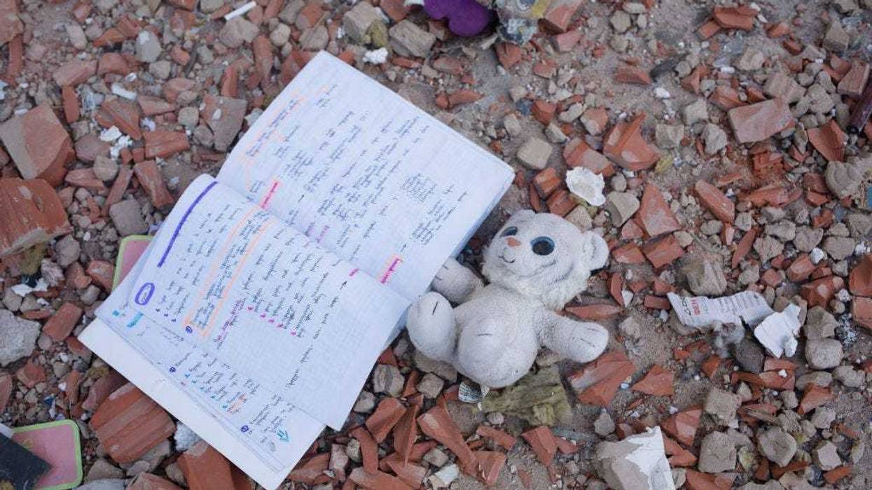 A toy and a note book lies among the debris by the apartment block in 6A Lobanovsky Avenue which was hit with a missile on February 26, 2022 in Kyiv, Ukraine. A residential building was hit as missile strikes were reported around Kyiv on the second night of Russia’s invasion of Ukraine, which has killed scores and prompted widespread condemnation from US and European leaders. (Photo by Anastasia Vlasova/Getty Images)