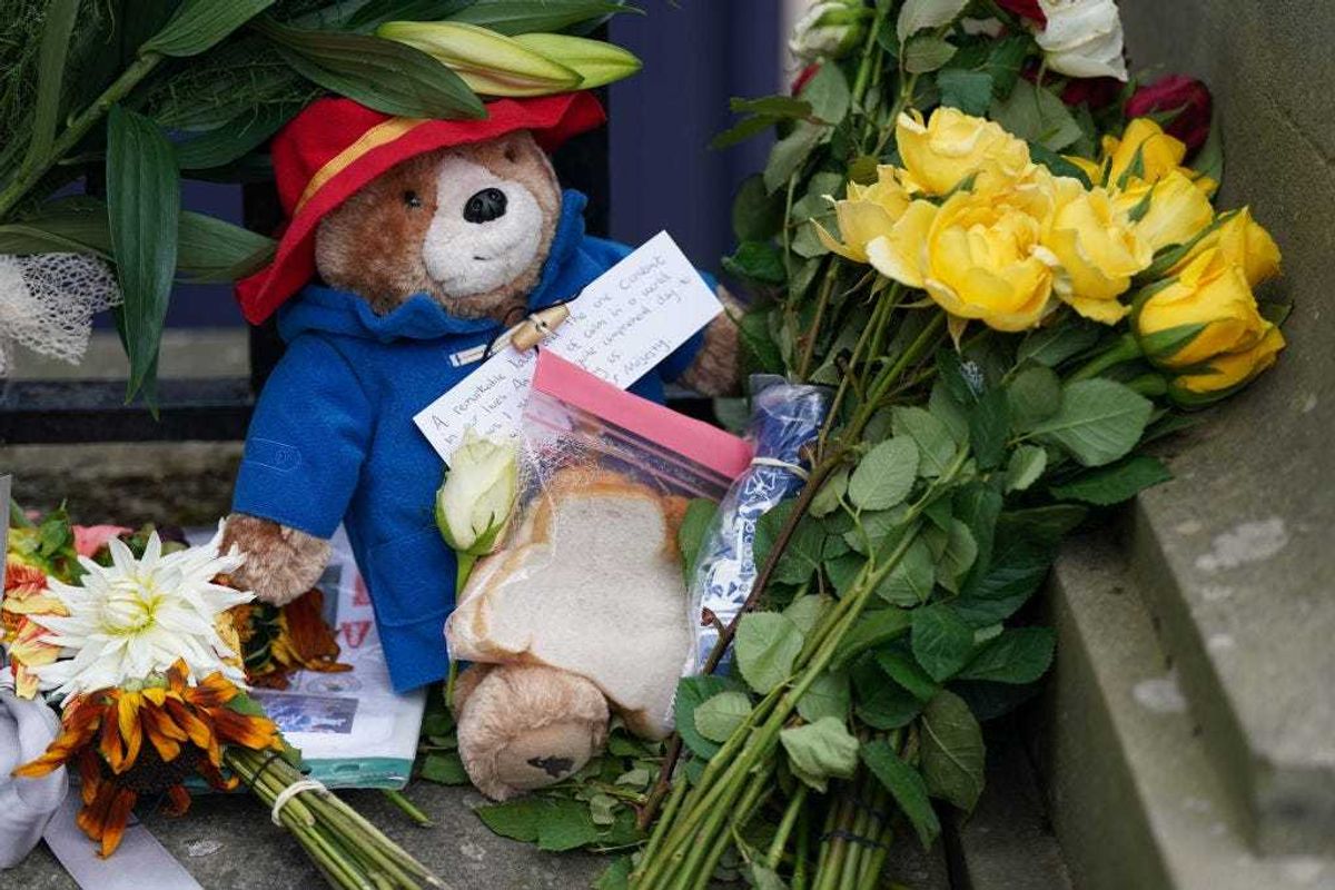 A toy Paddington Bear and a marmalade sandwich, a nod to the Queen's association with the children's book character at the Royal Jubilee, is laid outside the Palace of Holyroodhouse on September 12, 2022 in Edinburgh, Scotland. King Charles III joins the procession accompanying Her Majesty The Queen's coffin from the Palace of Holyroodhouse along the Royal Mile to St Giles Cathedral. The King and The Queen Consort, accompanied by other Members of the Royal Family also attend a Service of Prayer and Reflection for the Life of The Queen where it lies in rest for 24 hours before being transferred by air to London. (Photo by Jacob King-WPA Pool/Getty Images)