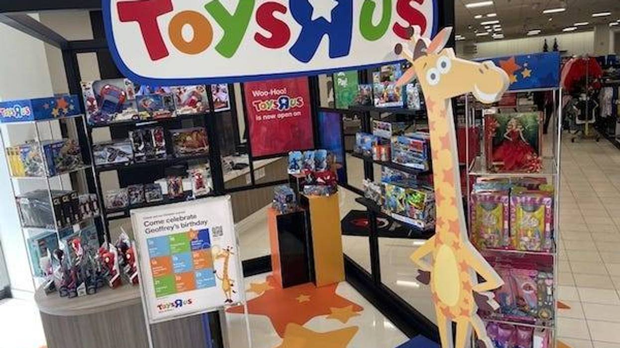 A Toys R Us display showing shelves of toys and Geoffrey the cartoon giraffe mascot greet visitors to Macy's in Augusta Mall, Oct. 19, 2022