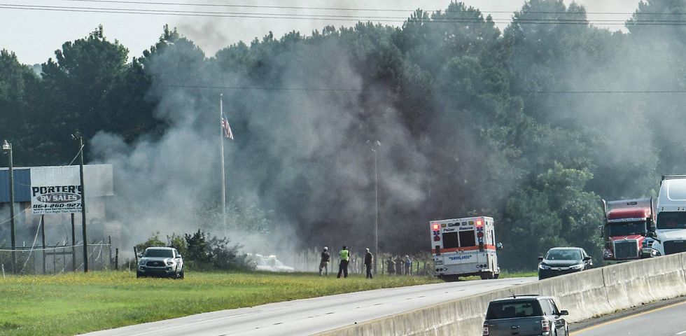 A tractor trailer burns after leaving I-85, crashing into a power transformer pole, near Welcome Road in Williamston, S.C. Tuesday, August 10, 2021.