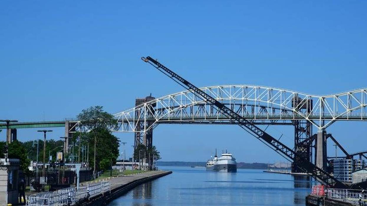 A trade ship approaches the Soo Locks as a gate is raised to let it enter
