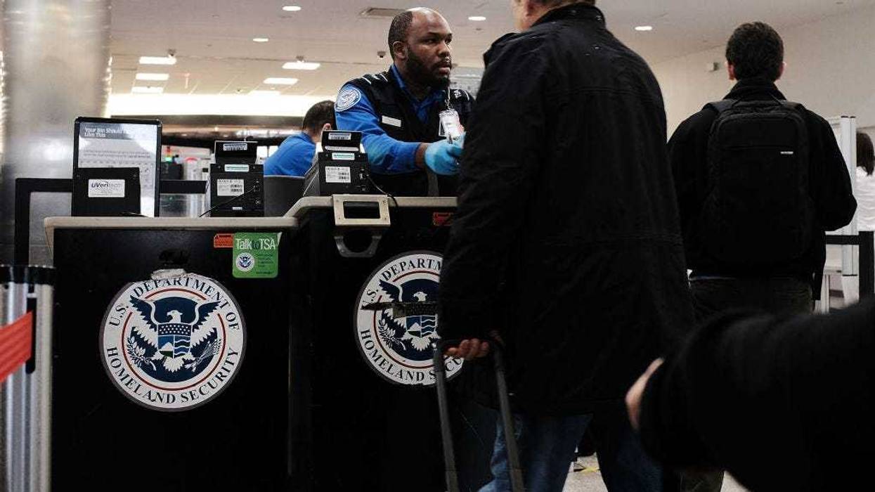 A Transportation Security Administration (TSA) worker screens passengers at LaGuardia Airport (LGA) on the day before Thanksgiving, the nation's busiest travel day on November 22, 2017 in New York City.