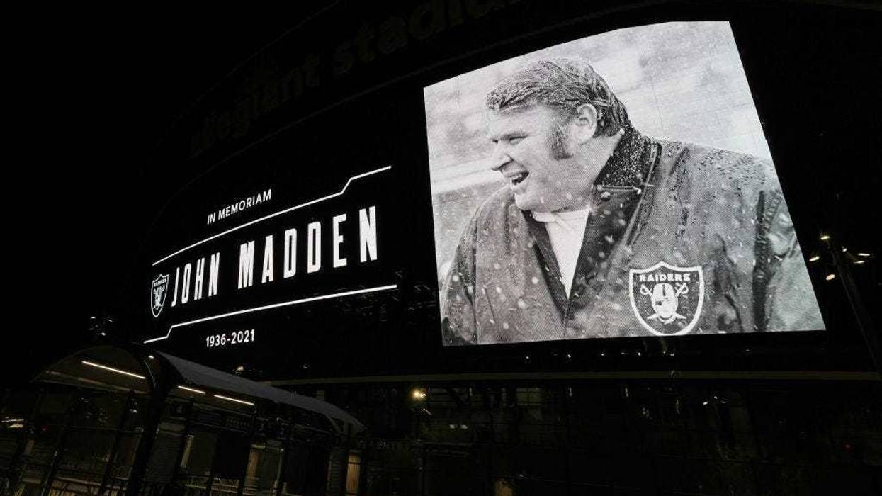 A tribute to former Raiders head coach, Pro Football Hall of Fame member and broadcaster John Madden is displayed on the side of Allegiant Stadium, home of the Las Vegas Raiders, after news of his death at the age of 85 on December 28, 2021 in Las Vegas, Nevada.