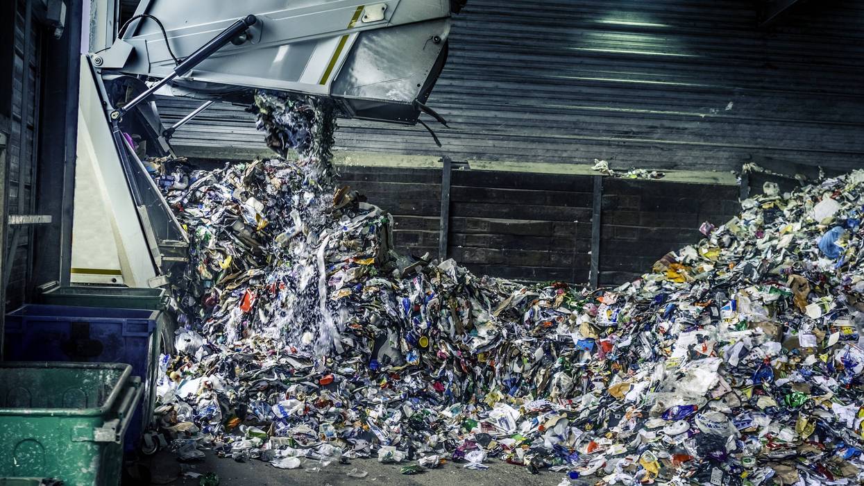 A truck drops off recycling at a plant.