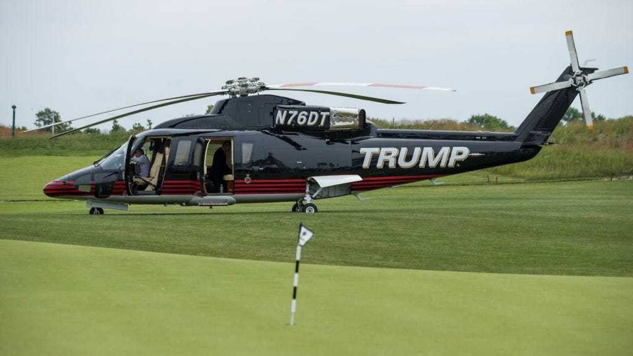 A 'TRUMP' branded helicopter sits near a putting green during a ribbon cutting event for a new clubhouse at Trump Golf Links at Ferry Point, June 11, 2018 in The Bronx borough of New York City.