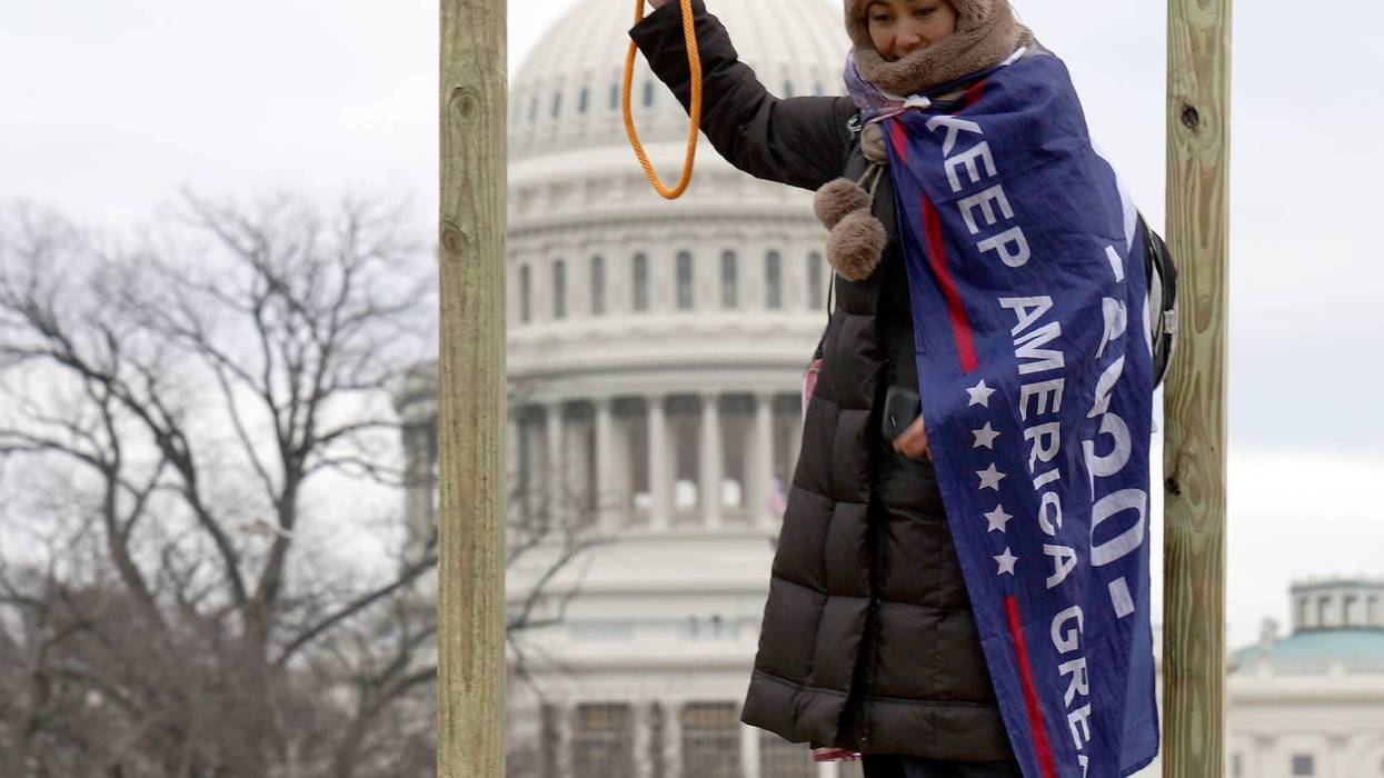 A Trump support at a gallows with noose at the insurrection at the Capitol