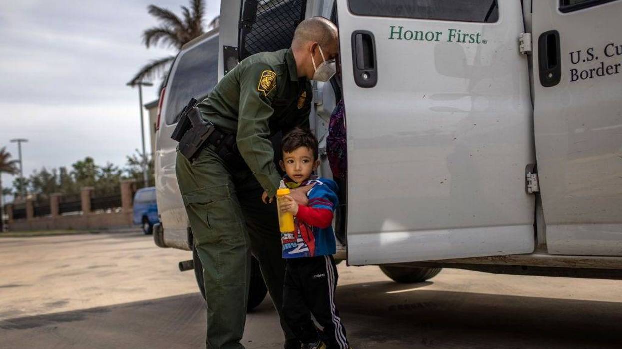A U.S. Border Patrol agent delivers a young asylum seeker and his family to a bus station on February 26, 2021 in Brownsville, Texas. U.S. immigration authorities are now releasing many asylum seeking families after detaining them while crossing the U.S.-Mexico border. The immigrant families are then free to travel to destinations throughout the U.S. while awaiting asylum hearings.