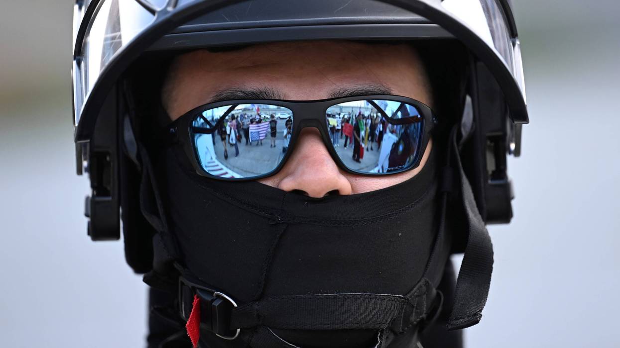 A U.S. Customs and Border Patrol agent looks on during a protest outside the Federal Building on Friday, June 13, 2025, in Los Angeles.