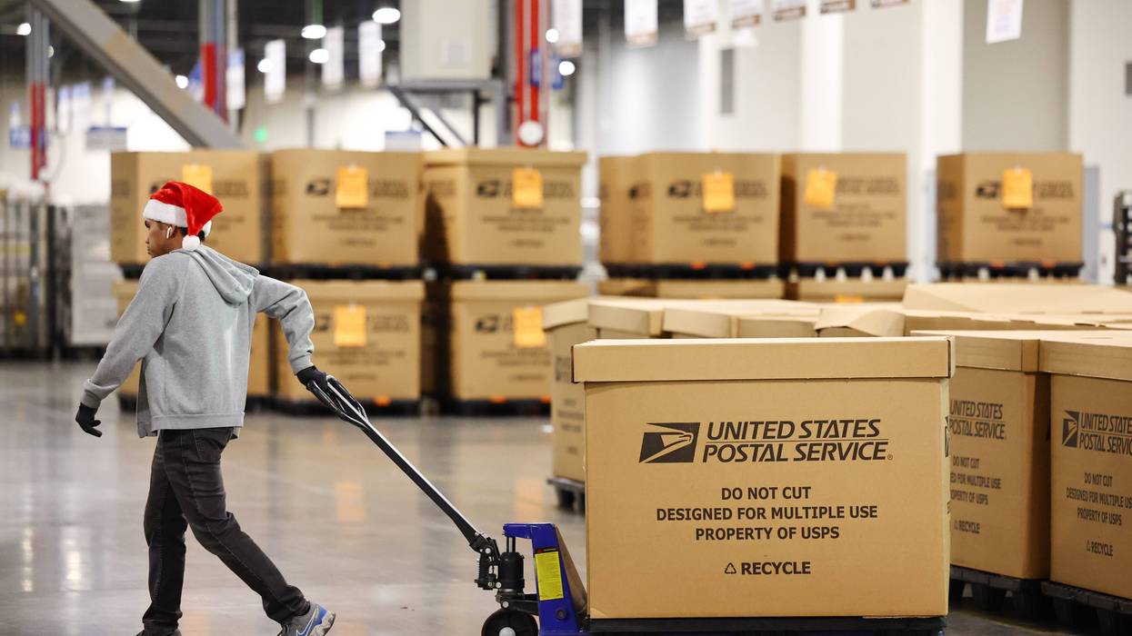 A U.S. Postal Service employee works ahead of the holiday mail rush inside the Los Angeles Processing and Distribution Center on Nov. 30, 2022 in Los Angeles, California.