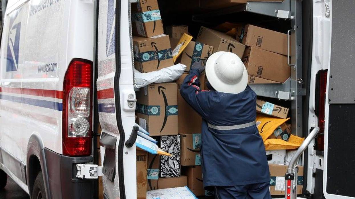 A U.S. Postal Service (U.S.P.S.) worker unpacks packages from a truck on December 02, 2019 in San Francisco, California.