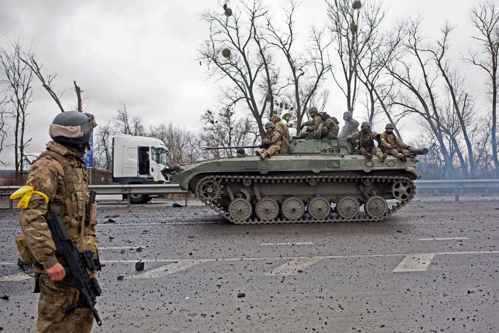 A Ukrainian APC drives on the road on March 3, 2022 in Sytniaky, Ukraine, west of the capital