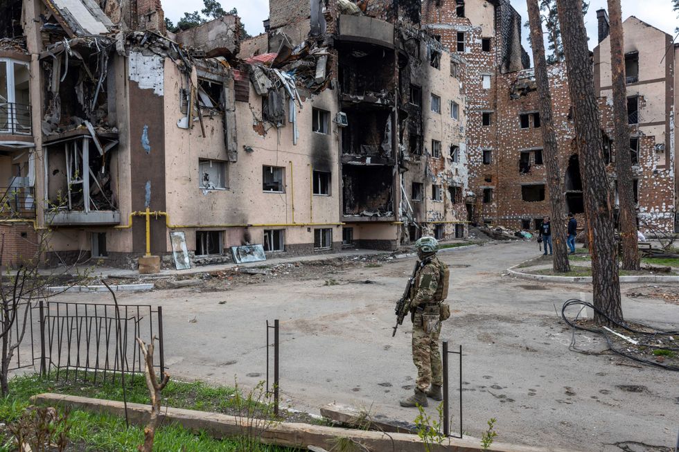 A Ukrainian army soldier stands guard at the war damaged Irpinsky Lipky residential complex following the visit of United Nations Secretary-General Antonio Guterres on April 28, 2022 in Irpin, Ukraine