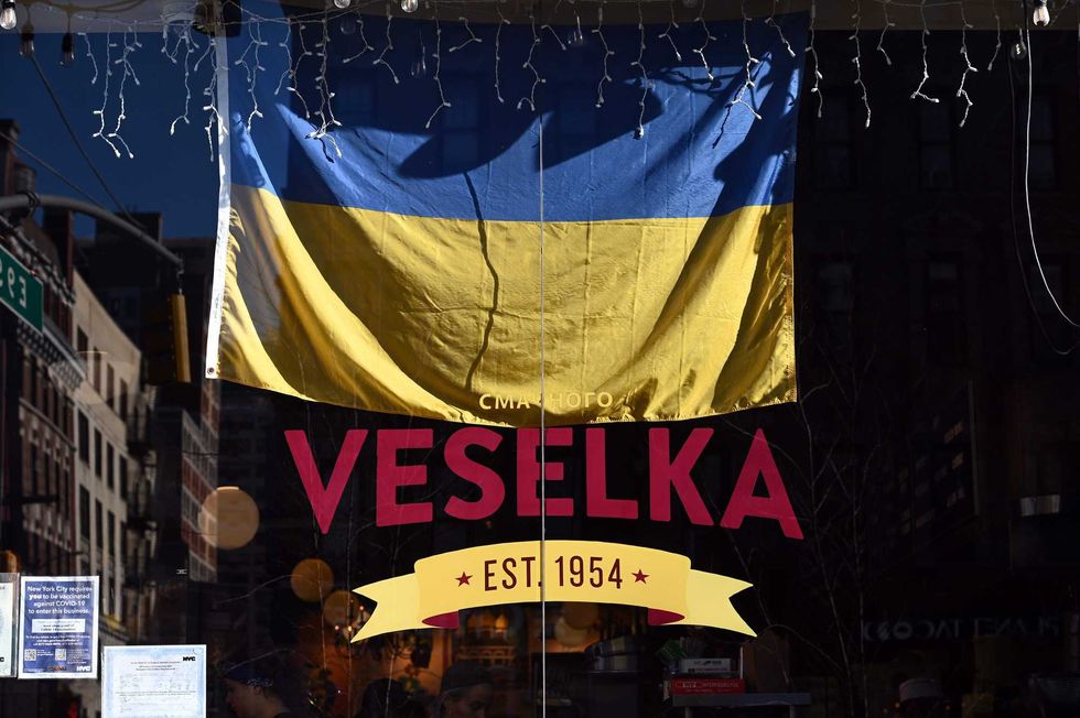 A Ukrainian flag hangs in the widow of Veselka restaurant, the Ukrainian eatery in Manhattan