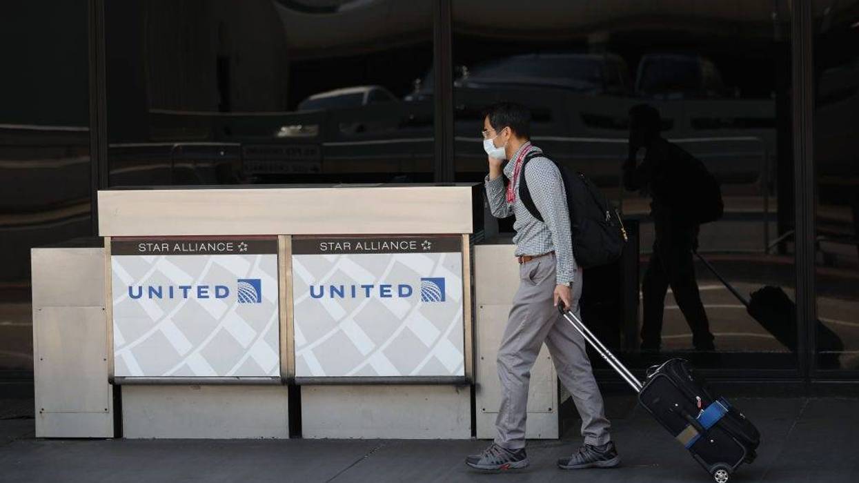 A United Airlines passenger walks by a closed curbside check in booth at San Francisco International Airport on September 02, 2020 in San Francisco, California.