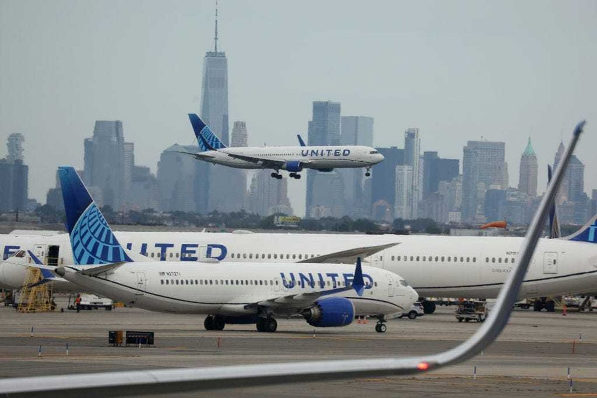 A United Airlines plane lands at Newark Liberty International Airport in front of the New York skyline on September 17, 2023 in Newark, New Jersey.